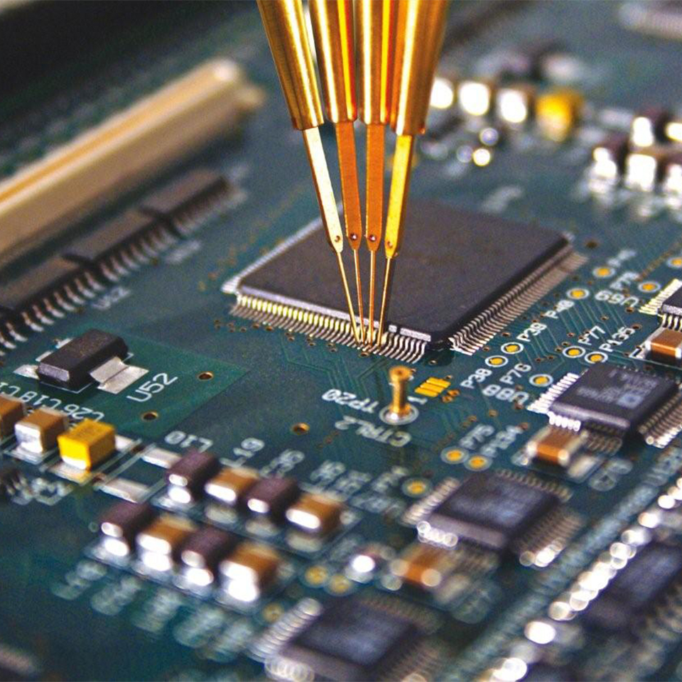 Close-up of multiple golden test probes touching the pins of a microchip on a circuit board.
