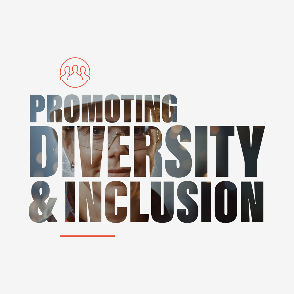 Text overlay on image of a woman with safe hat and glasses: Promoting Diversity & Inclusion.