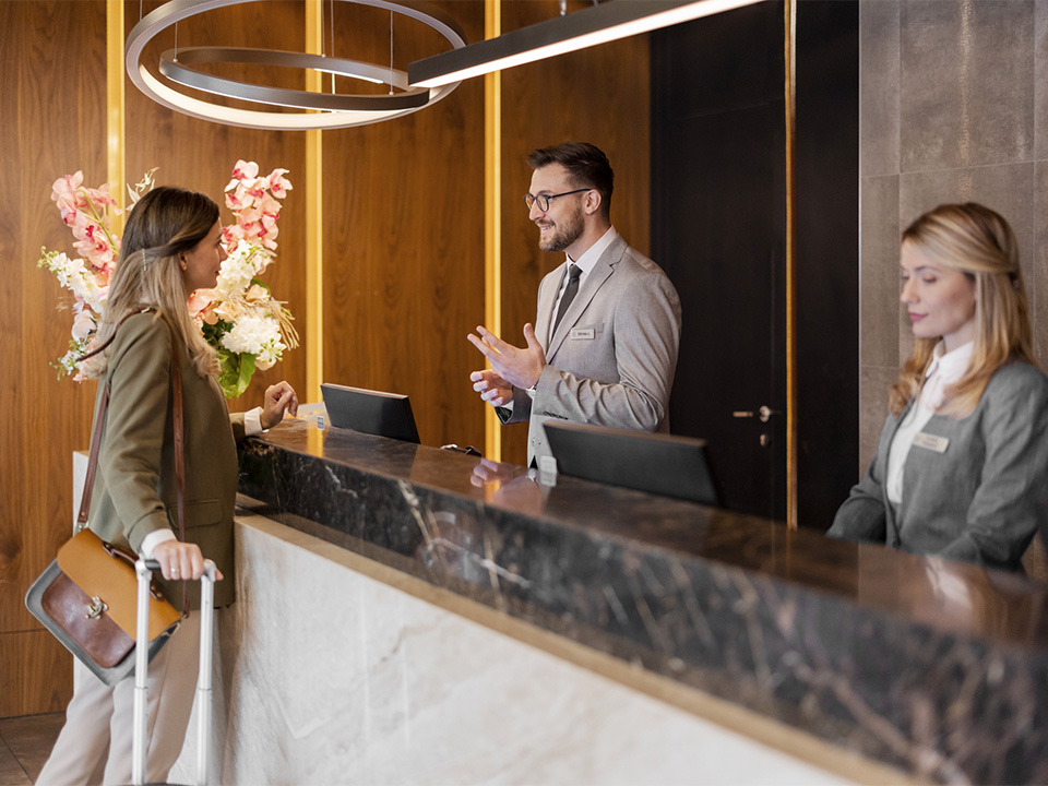 Receptionist talking to a customer in a hotel