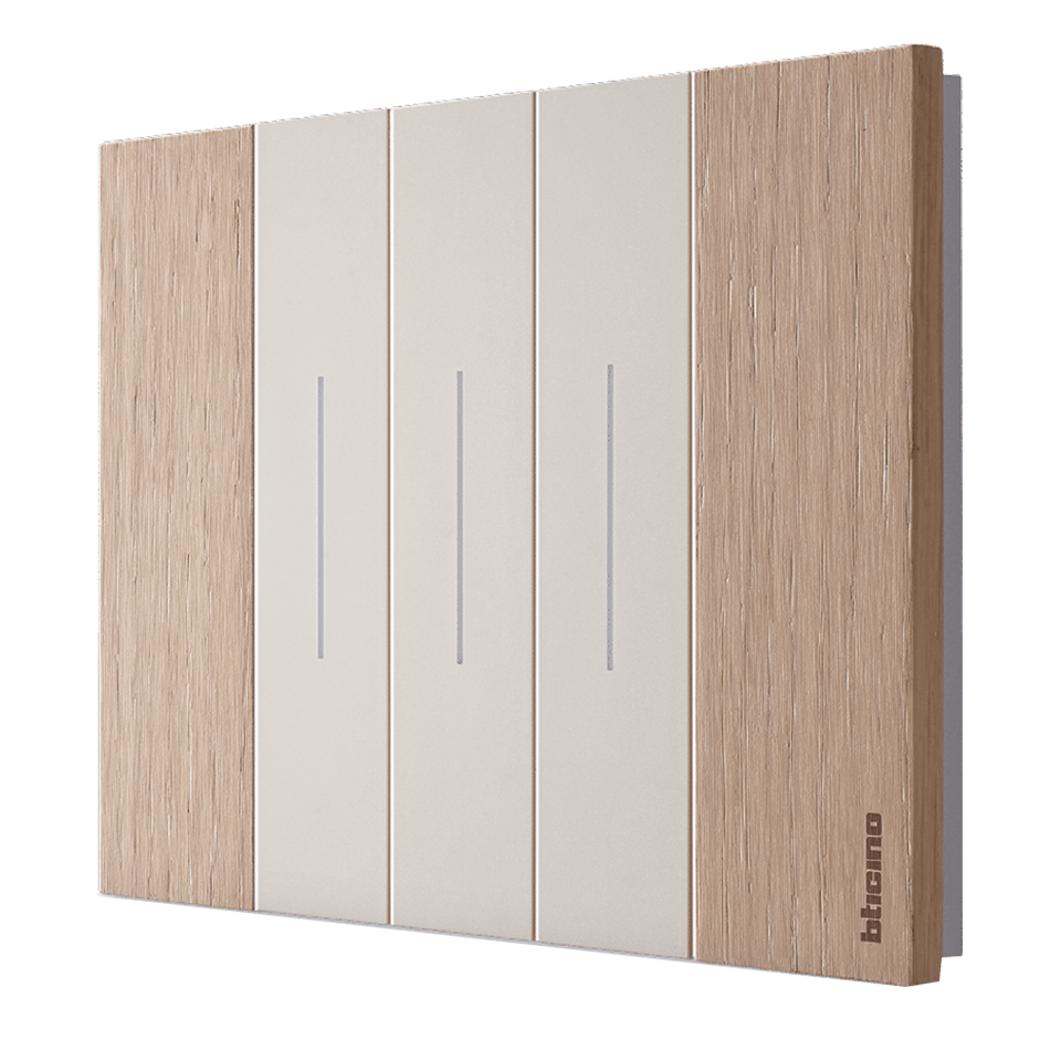 A 3-module Living Now wall switch with Oak cover plate and sand switches.