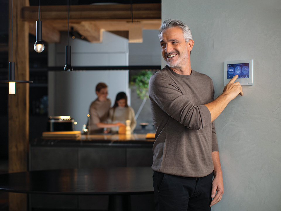 Close-up of multiple golden test probes touching the pins of a microchip on a circuit board.
