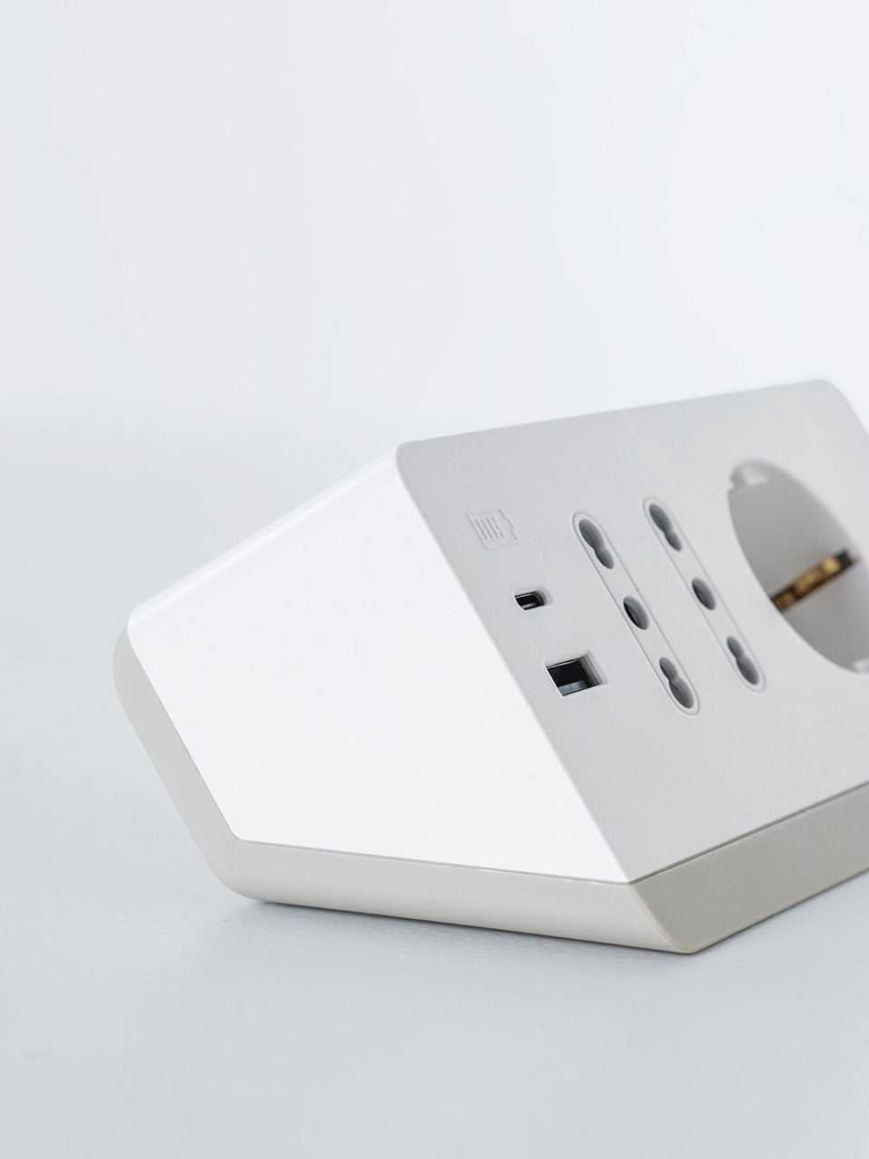 BTicino white angled power strip with USB ports and multiple sockets on a plain light background.